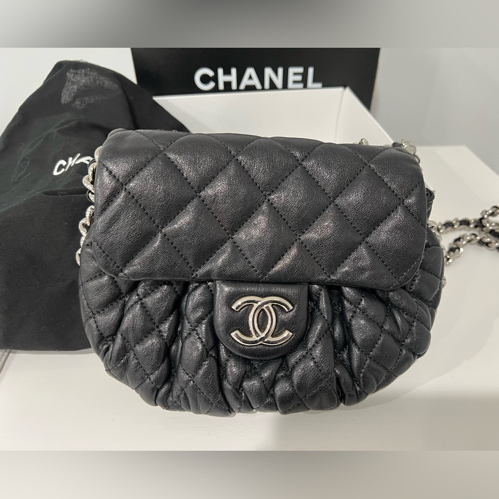 Authentic Chanel lambskin quilted around flap black with silver chain.